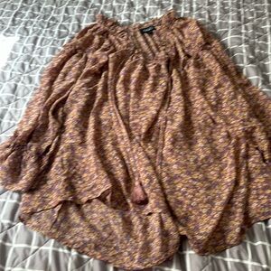 Silky blouse with flowers. It’s an oversized small that flows beautiful.